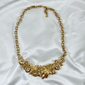 Vintage gold tone statement necklace with floral design.
